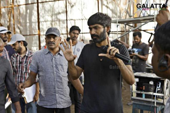 Dhanush explaining a sequence to cinematographer Velraj during Pa Paandi shoot